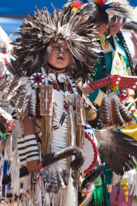 A young boy watches as others enter during the Grand Entry at Pow Wow in the Pines 2013.