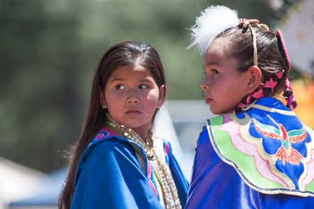 Young girls watch as other children enter the arena at Pow Wow in the Pines 2013.